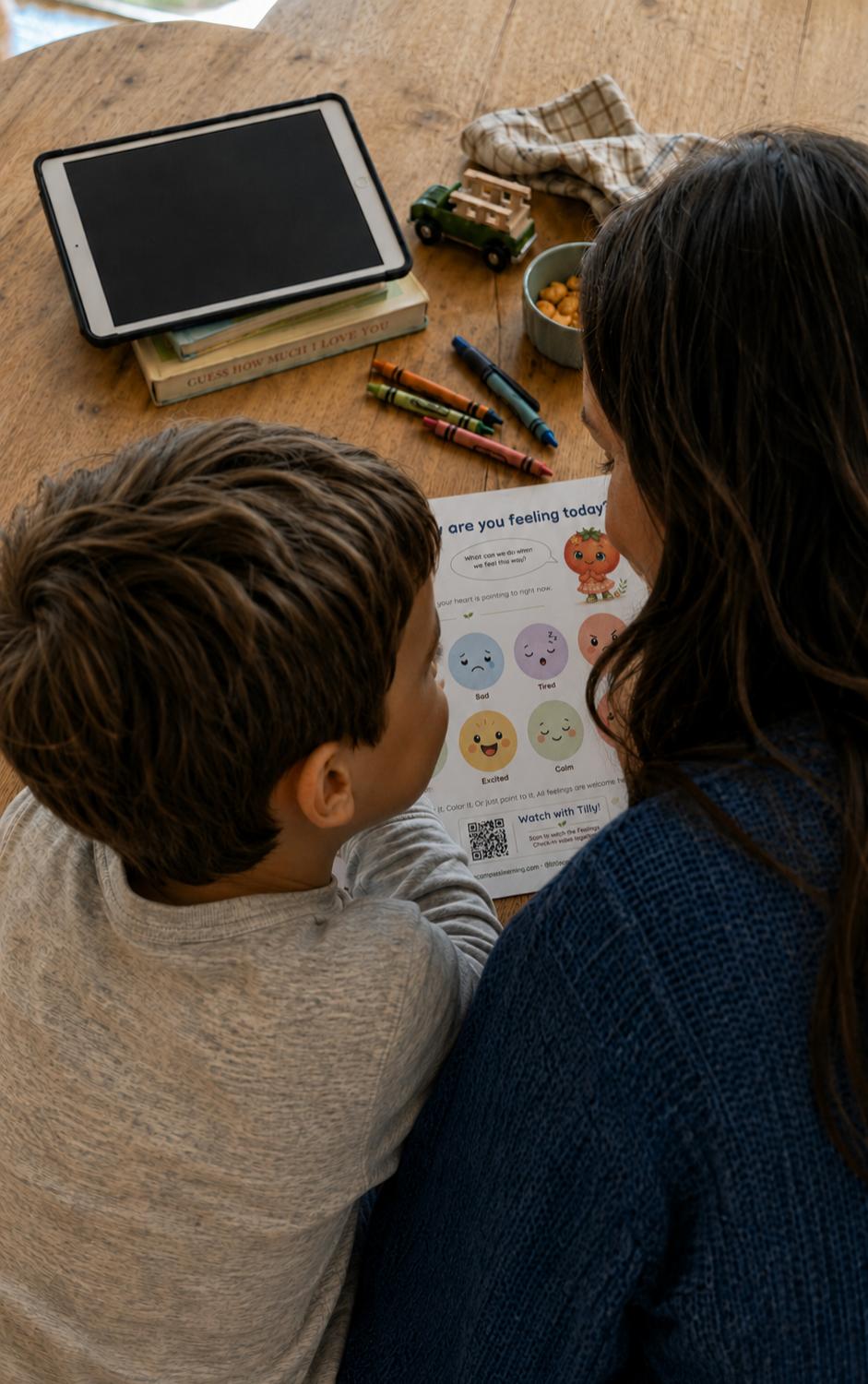 Parent and child doing a Little Compass Learning activity page together